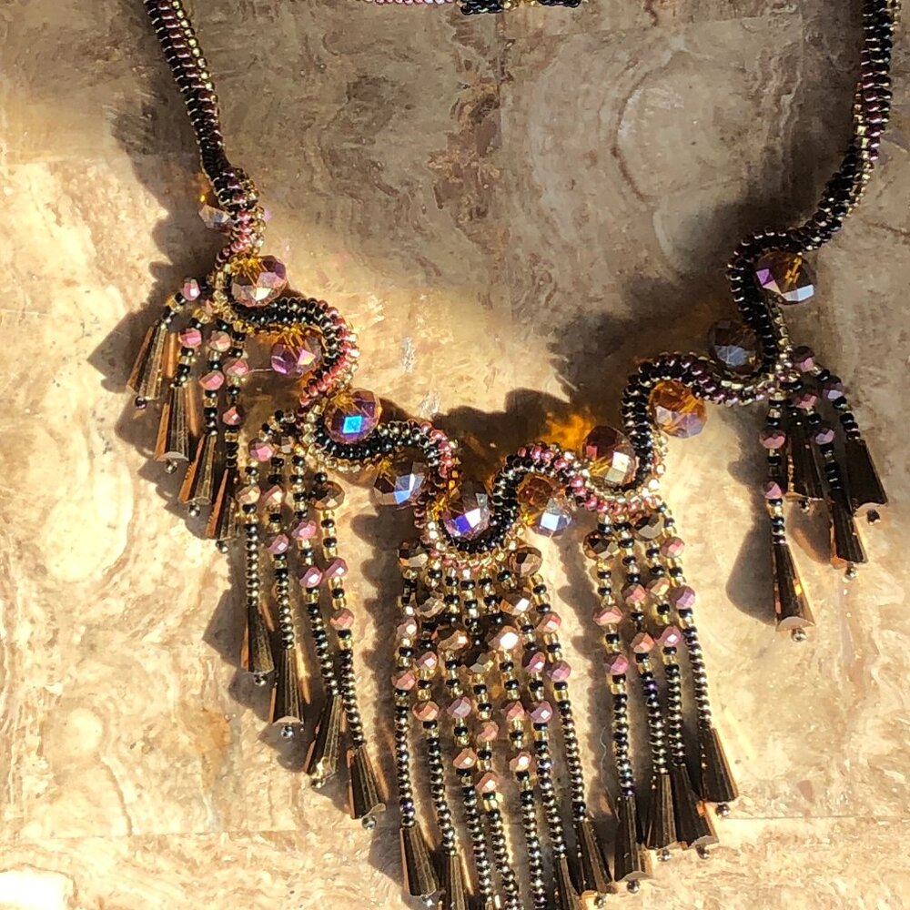 Brown beaded kumihimo necklace with pip beads and tassels